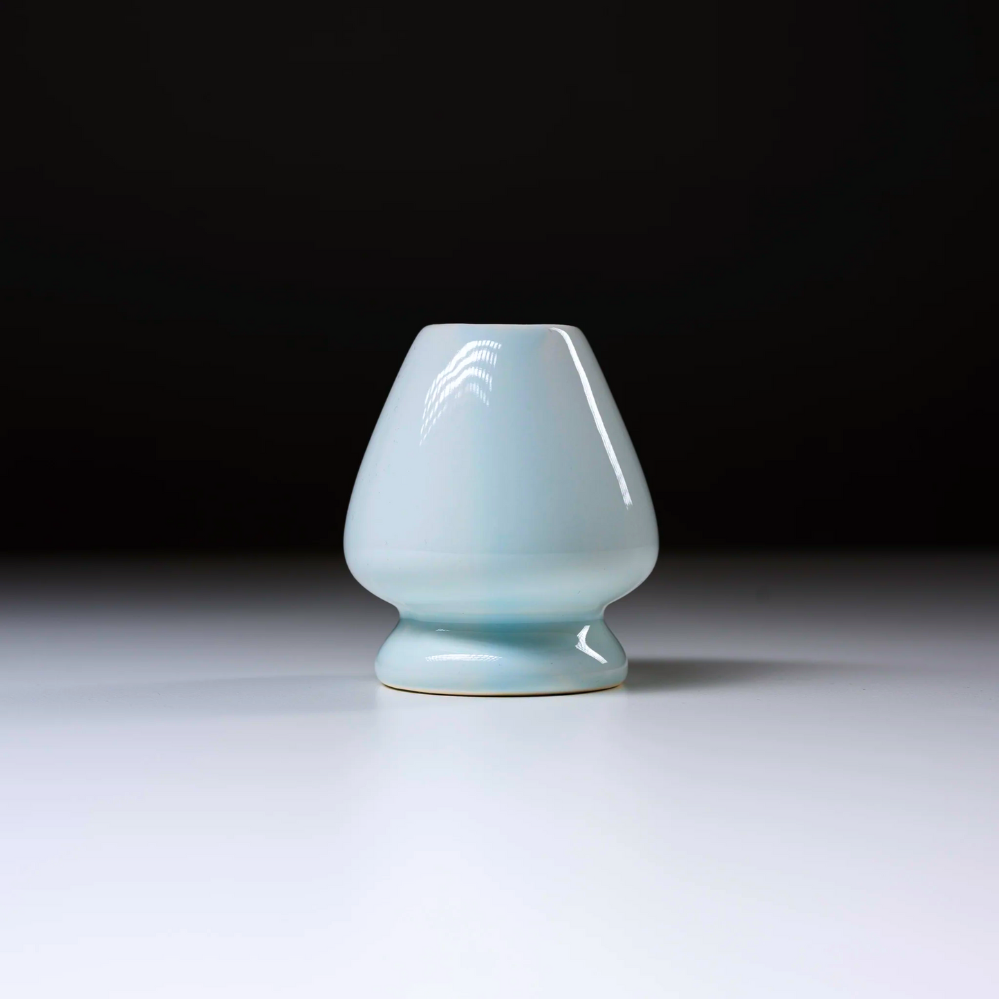 Ceramic vase with a light blue glaze on a white background