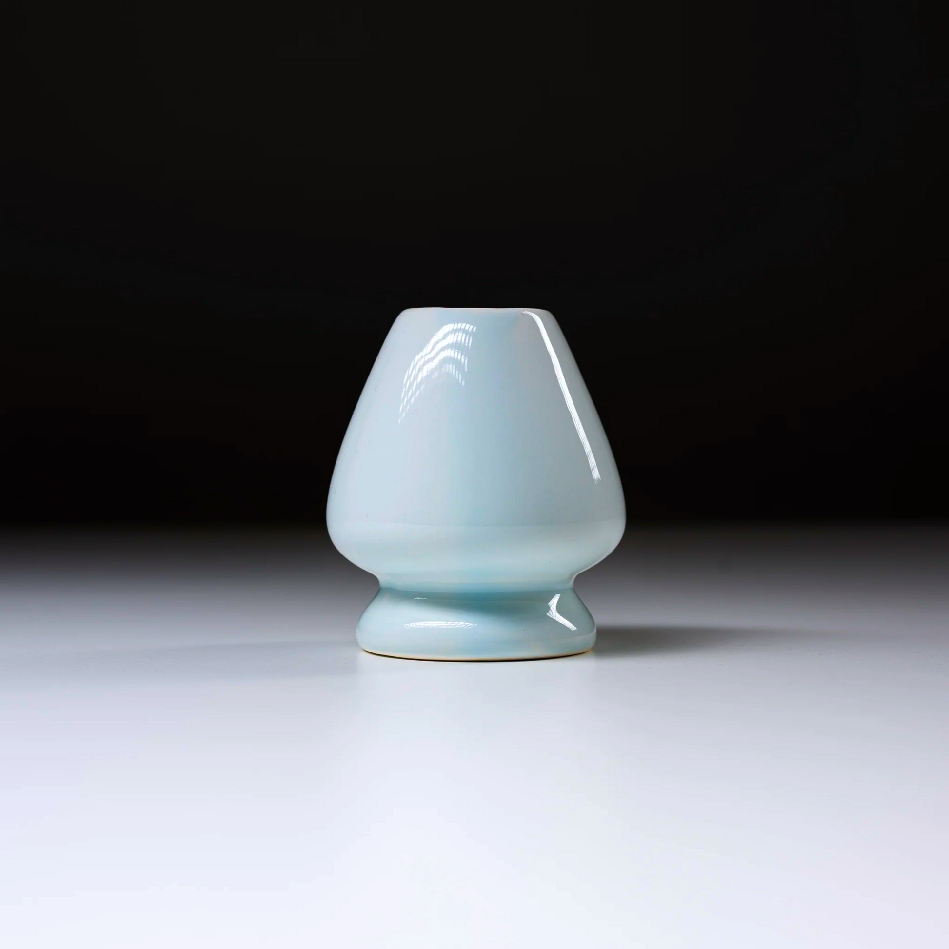 Ceramic vase with a light blue glaze on a white background